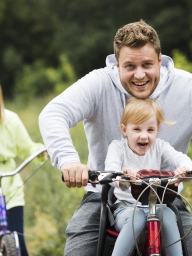 Happy family with bikes on forest road